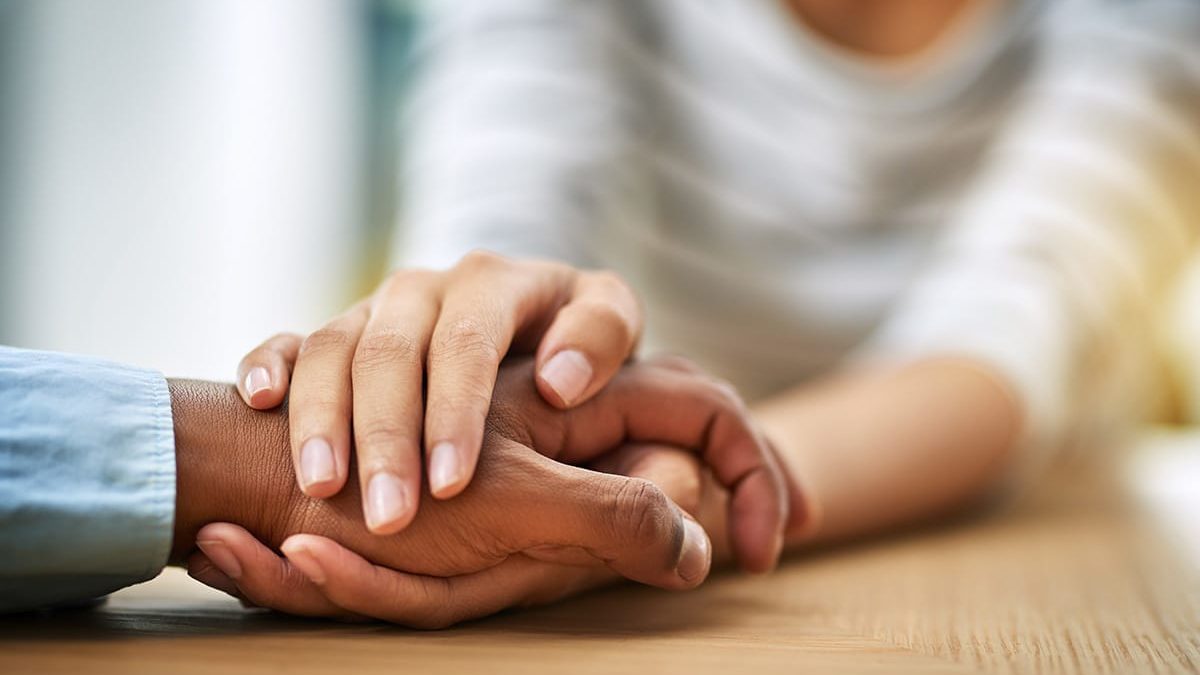 Person holding hands with another, learning how important connection is for beating addiction