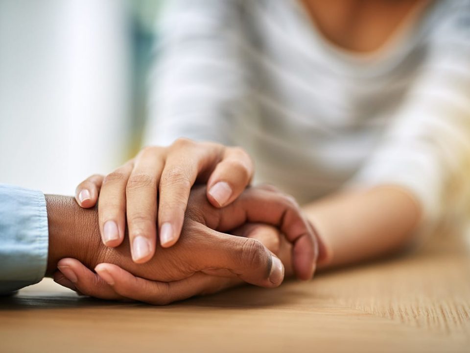 Person holding hands with another, learning how important connection is for beating addiction