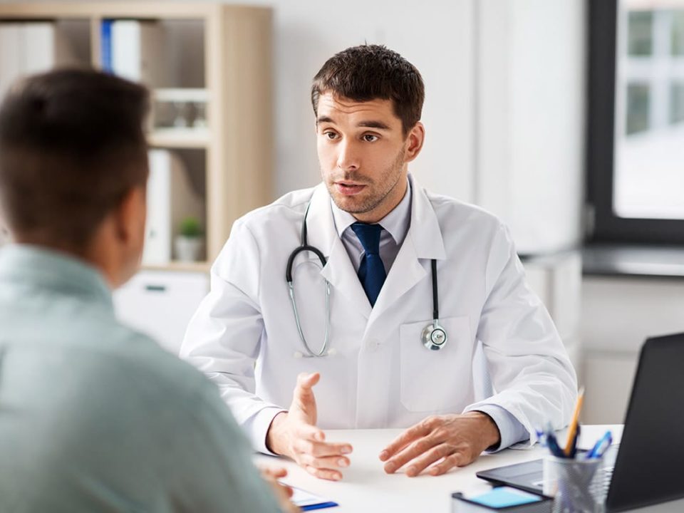 Doctor explains medically supervised treatment to a patient at his desk