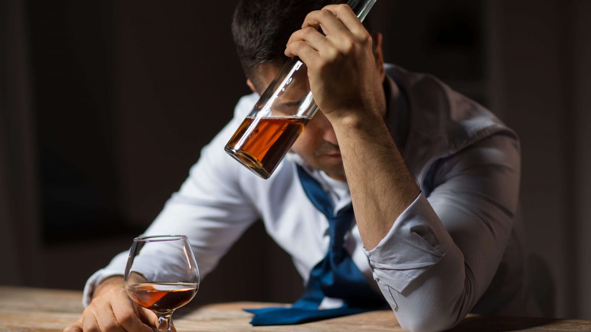 depressed man self medicating with alcohol