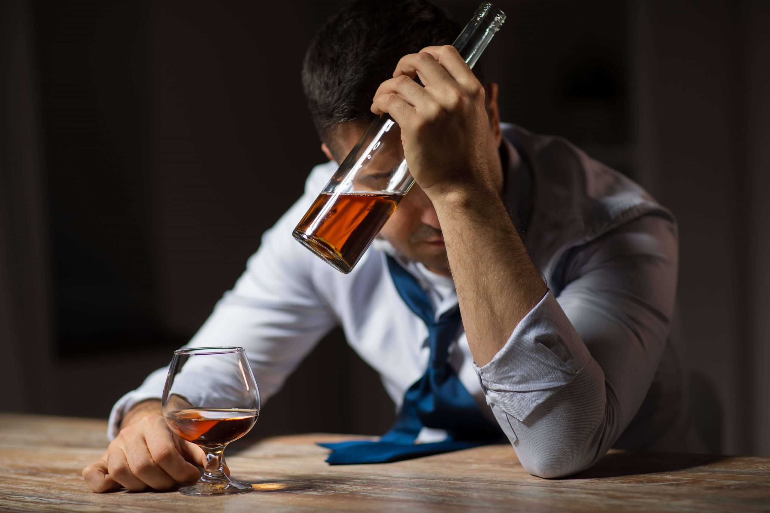 depressed man self medicating with alcohol