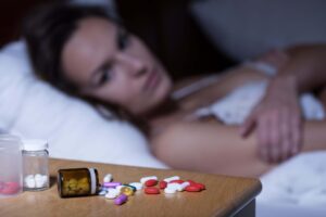 woman with insomnia addicted to sleeping pills