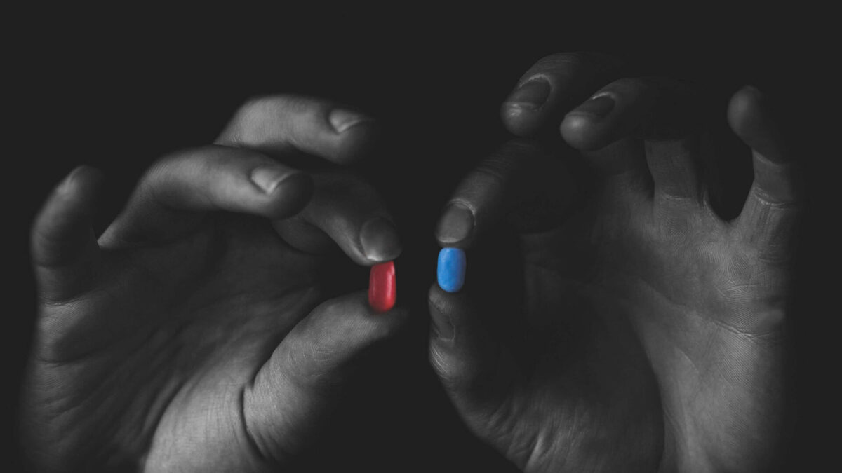 man holding two different prescription pills