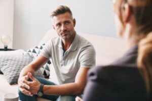 Man sits on couch as he discusses case management