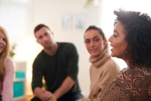 Patients sit in circle and bare their souls during group therapy session