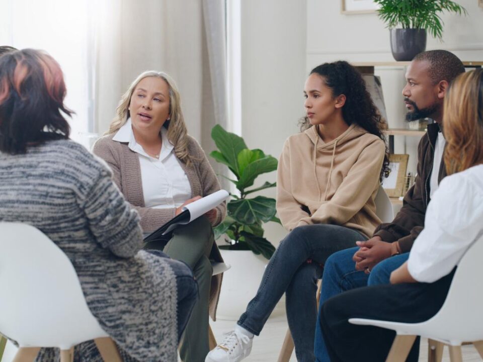 Patients sitting in group therapy, learning how to cope with trauma