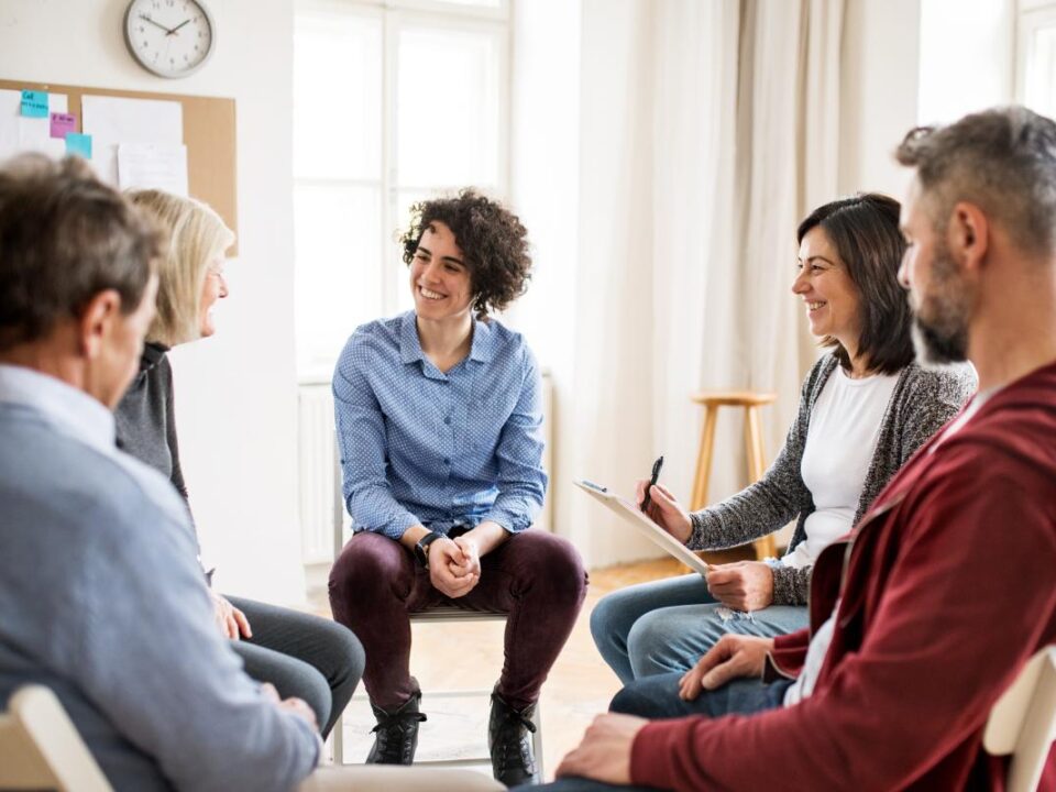 People sitting in an IOP group therapy asking, "what does IOP stand for?"