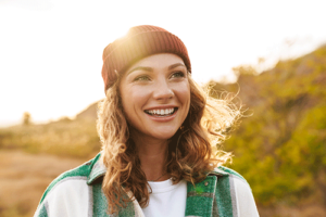 Woman smiles and stands in the sun after joining alumni program